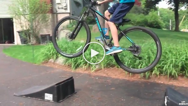 Замедленная съемка неудачного прыжка на велосипеде в исполнение мальчика